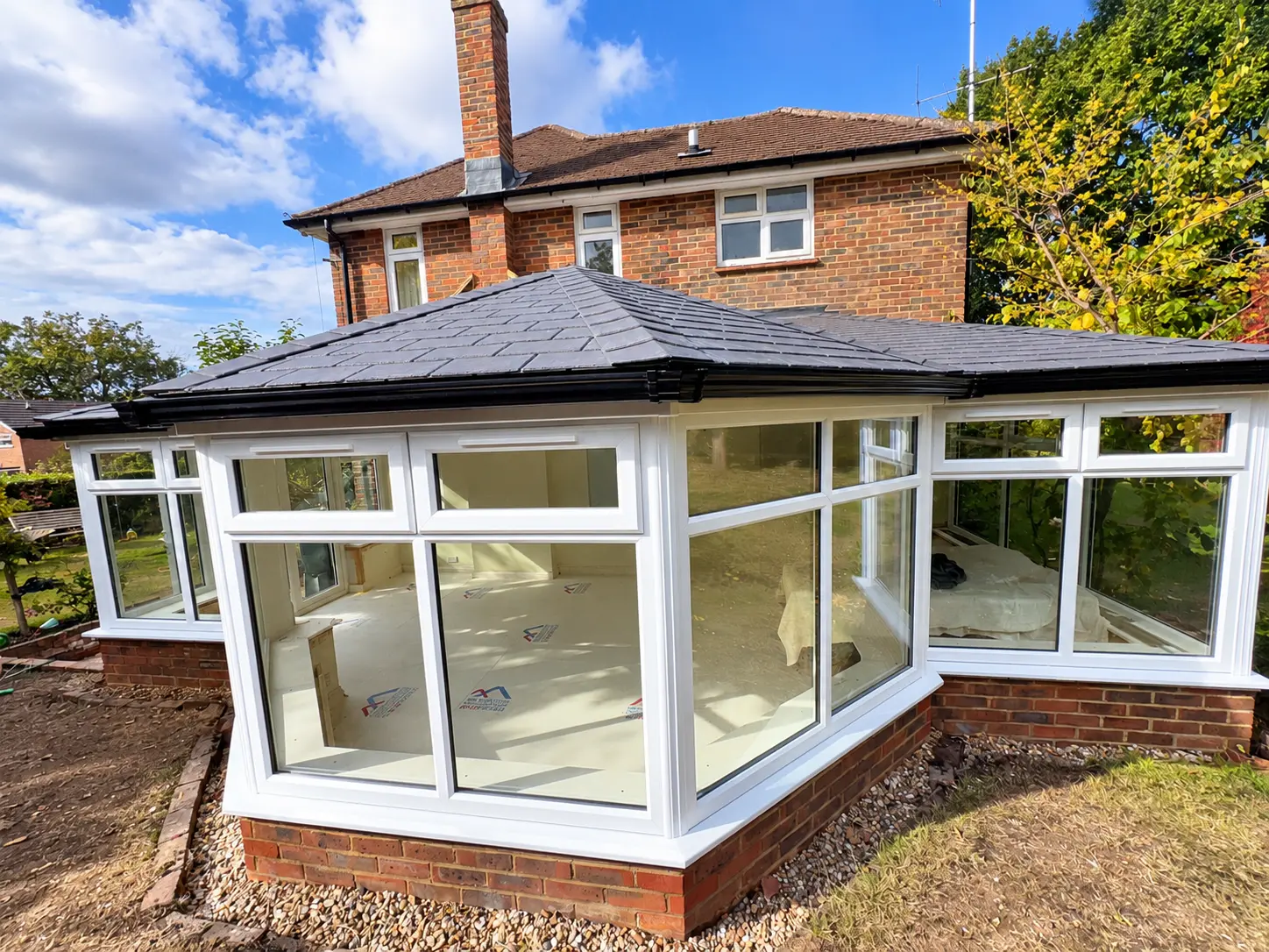 Tiled conservatory roof Completed conservatory transformation in Woking with new uPVC frames and an insulated tiled roof